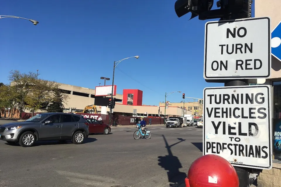 "No right turn on red" and "Turning vehicles yield to pedestrians" sign.